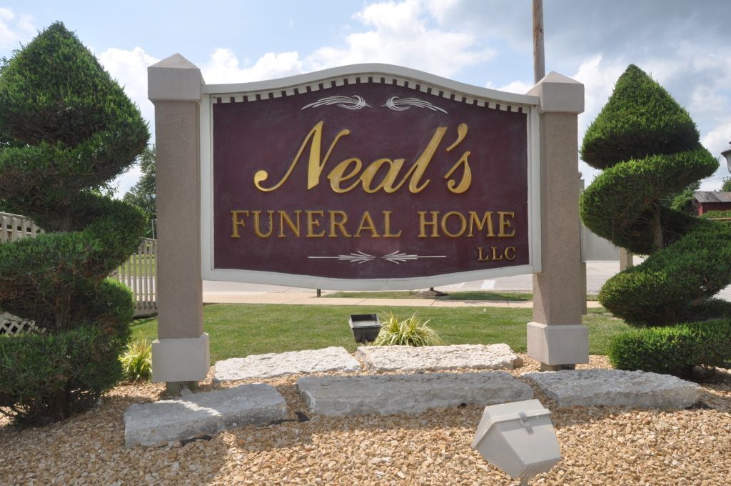A sign that says neal 's funeral home on it