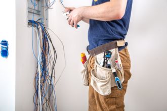 electrician-builder-at-work-examines-the-cable