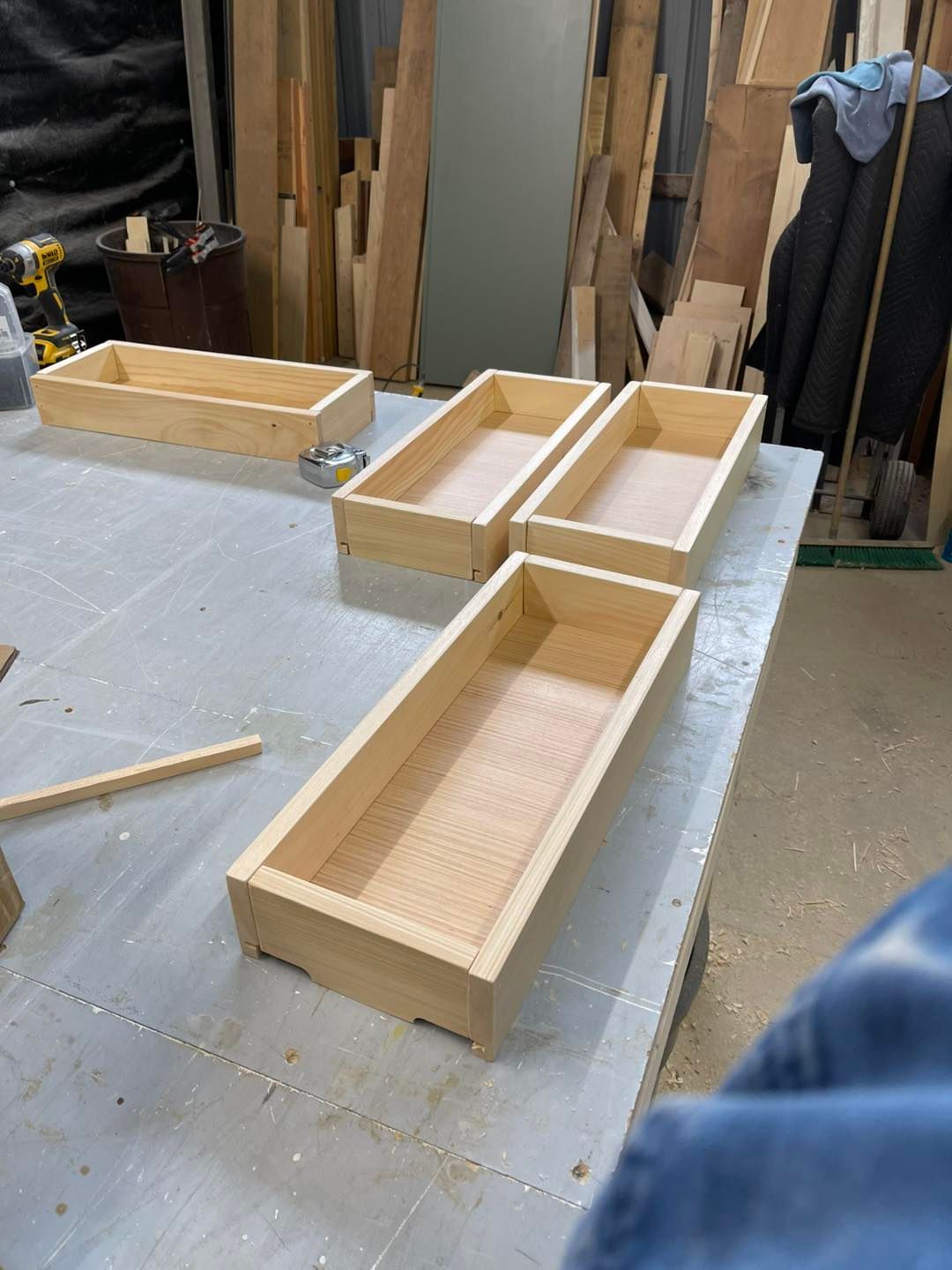 Wooden drawer boxes in a workshop setting.