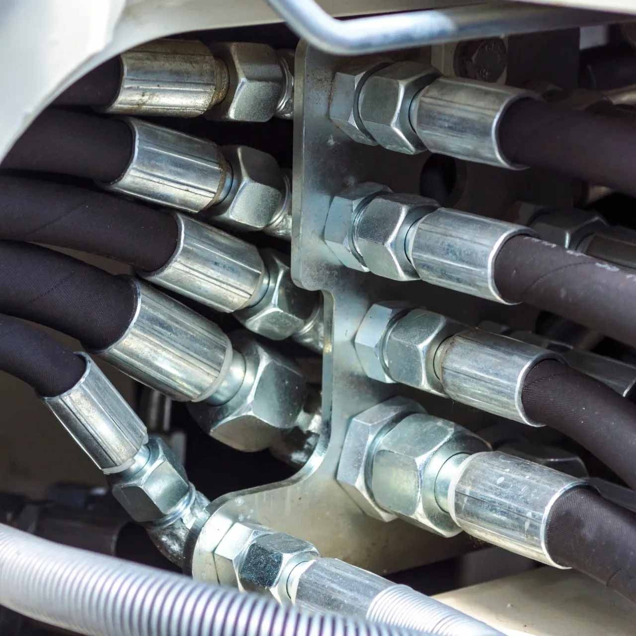 A bunch of hydraulic hoses are connected to a machine