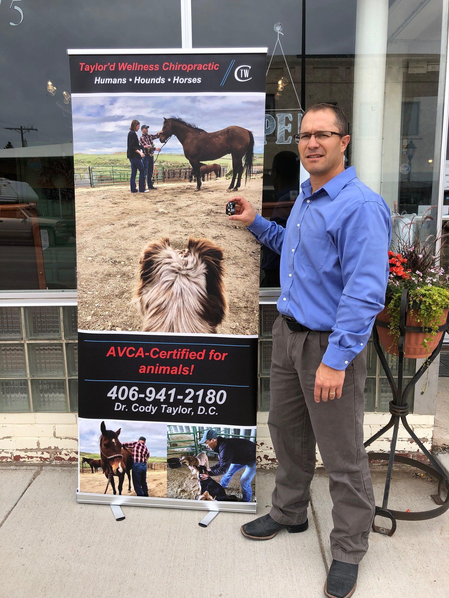A man is standing in front of a sign that says dvca-certified for animals.