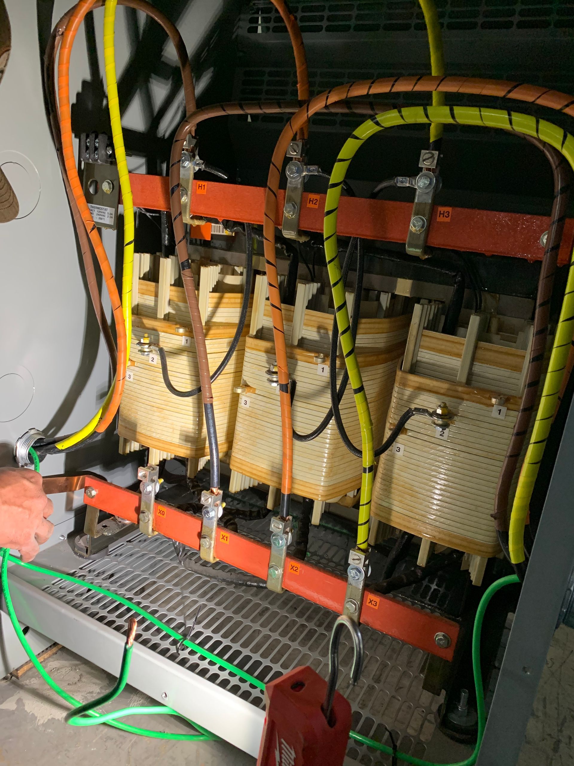 A Technician Diligently Repairs a Transformer in A Well-Lit Room | Bloomington, CA | Expressway Electric 