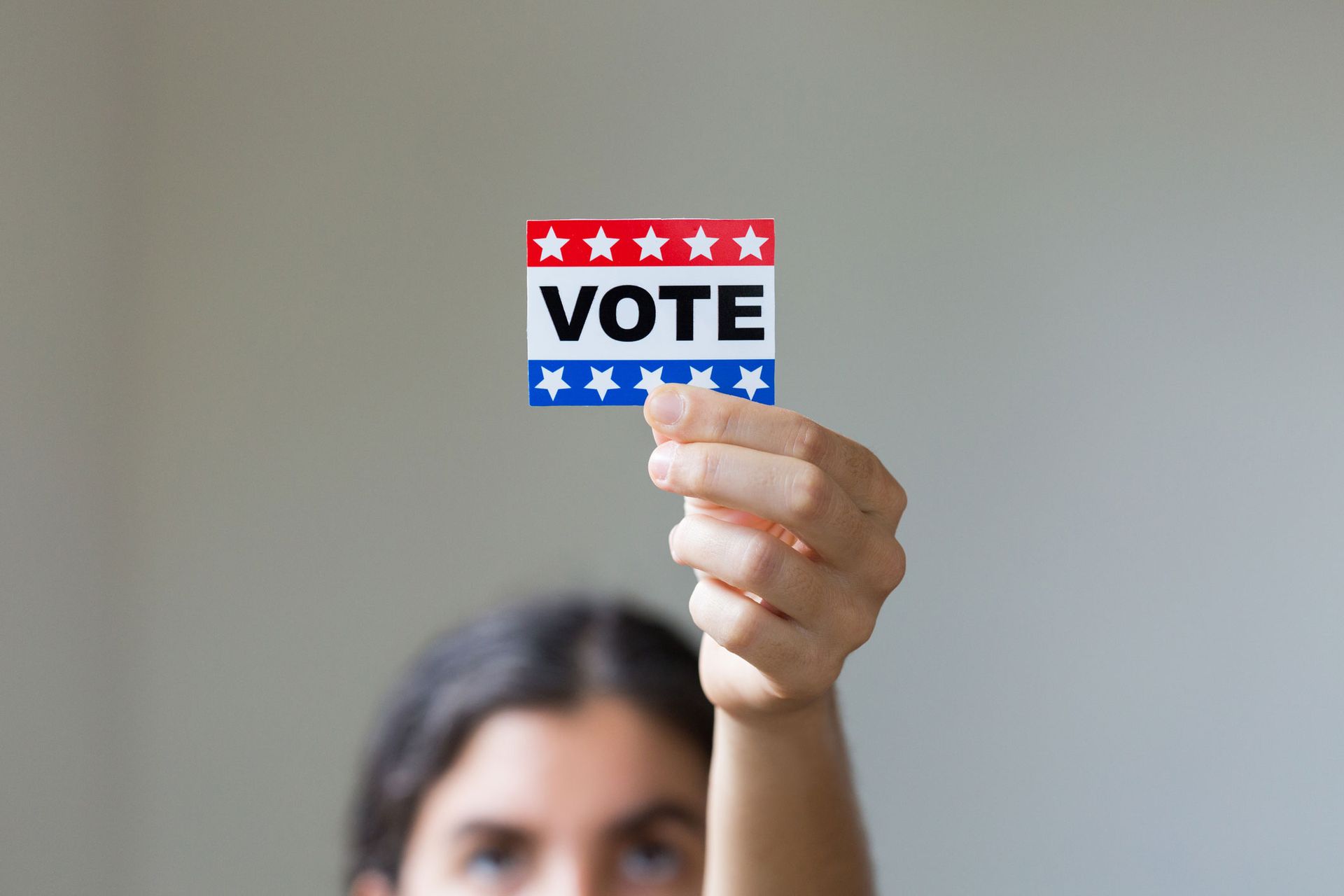 Woman Holding Vote Sticker — Kansas City, MO — Northland Strong