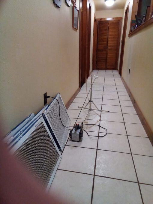 A long hallway with a fan on the floor