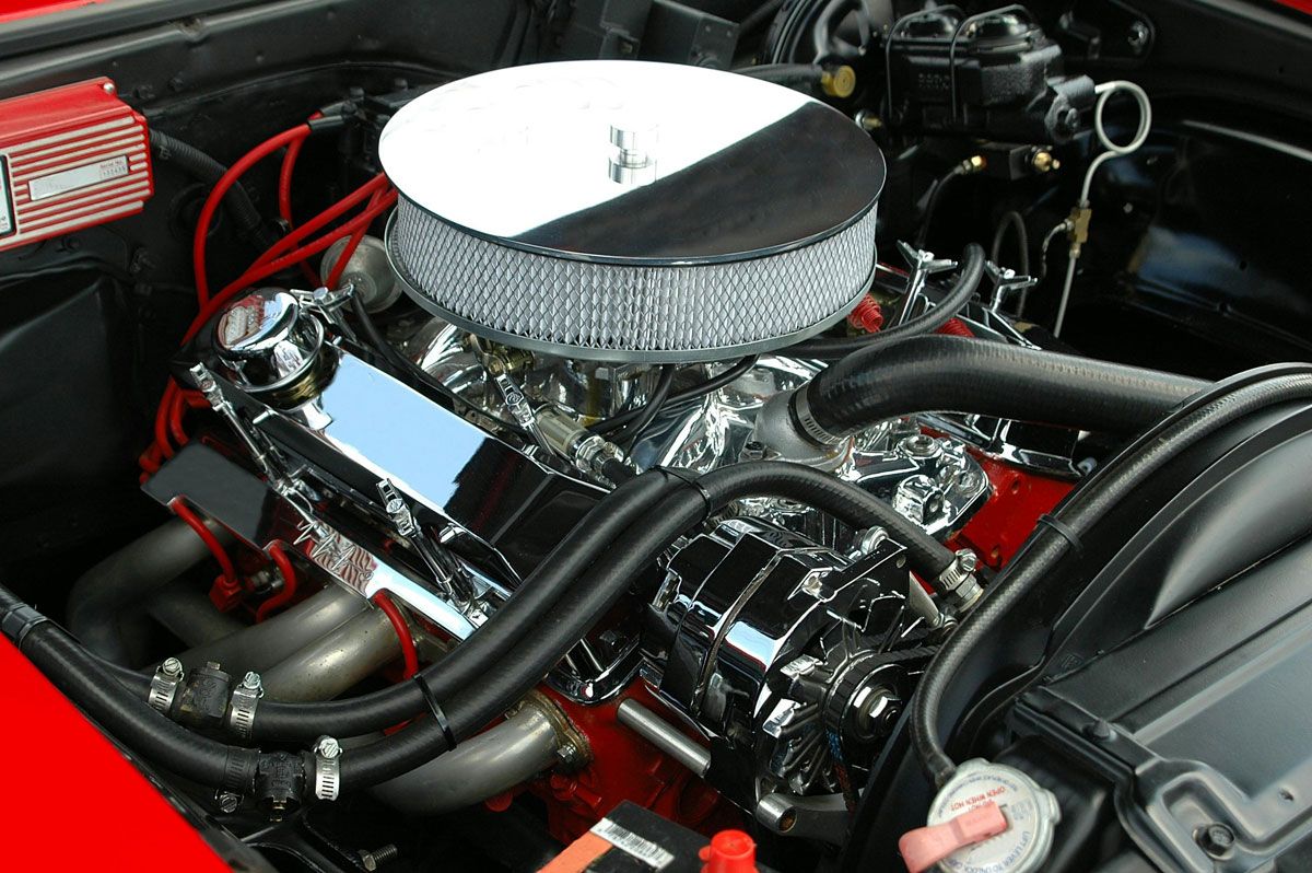 A close up of a car engine with a air filter