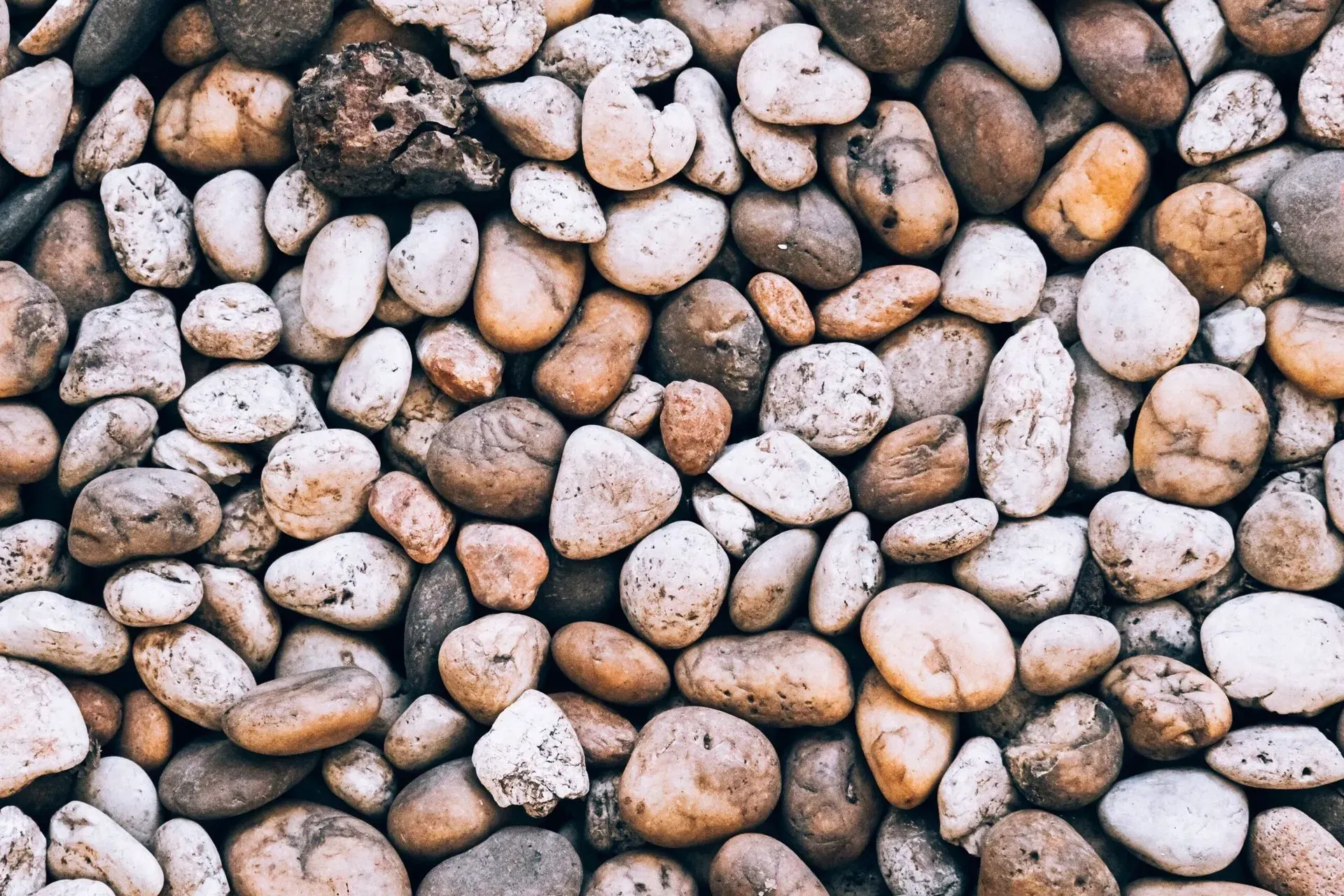 A pile of rocks sitting on top of each other on the ground.