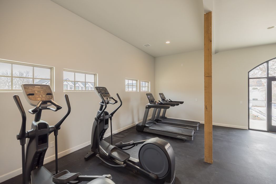 A dining room with a table and chairs and a ceiling fan.