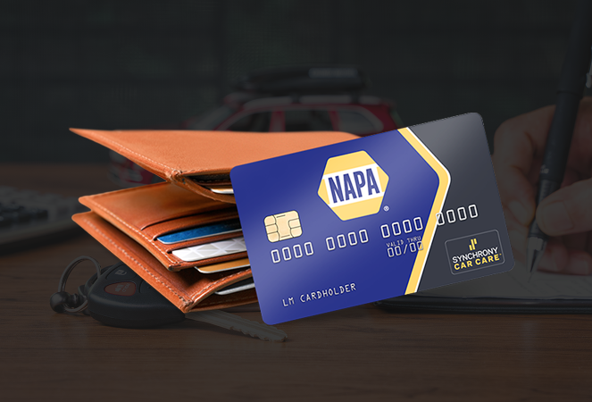 NAPA auto parts credit card next to a wallet, with a person writing in the background.  | Integrity Auto Repair