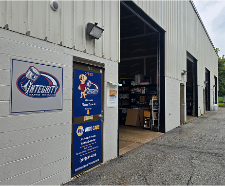 Auto repair shop exterior with open garage bays and sign: Integrity Auto Repair.  | Integrity Auto Repair