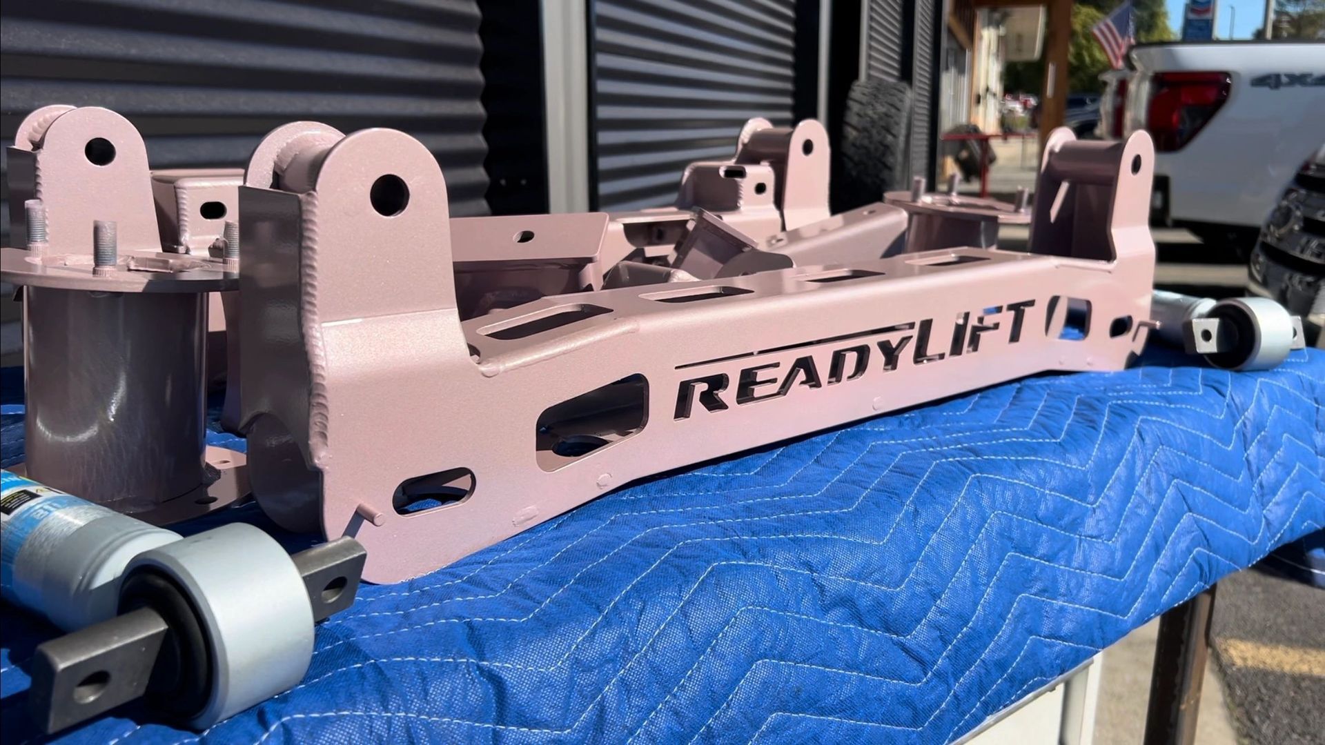 A piece of metal is sitting on top of a blue blanket on a table.