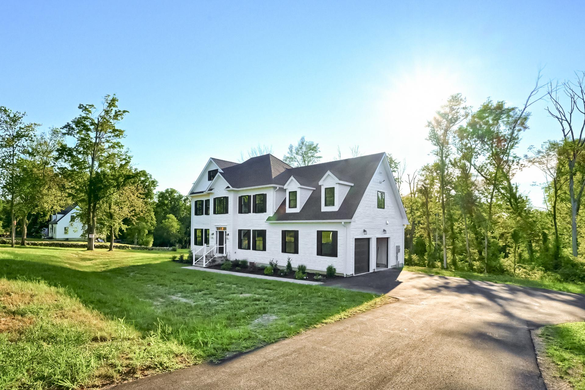 A large white house with a driveway leading to it