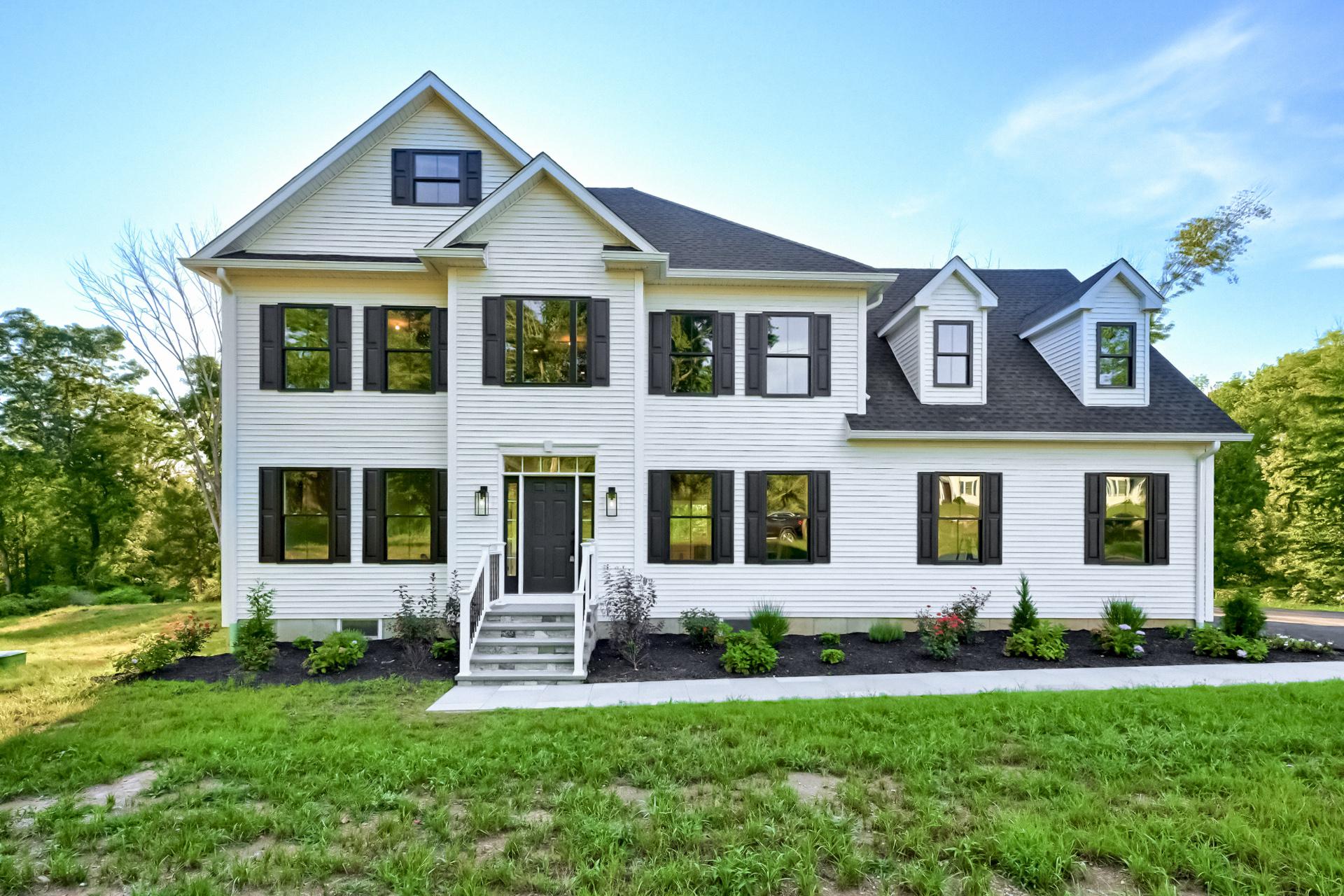 A large white house with black shutters on the windows