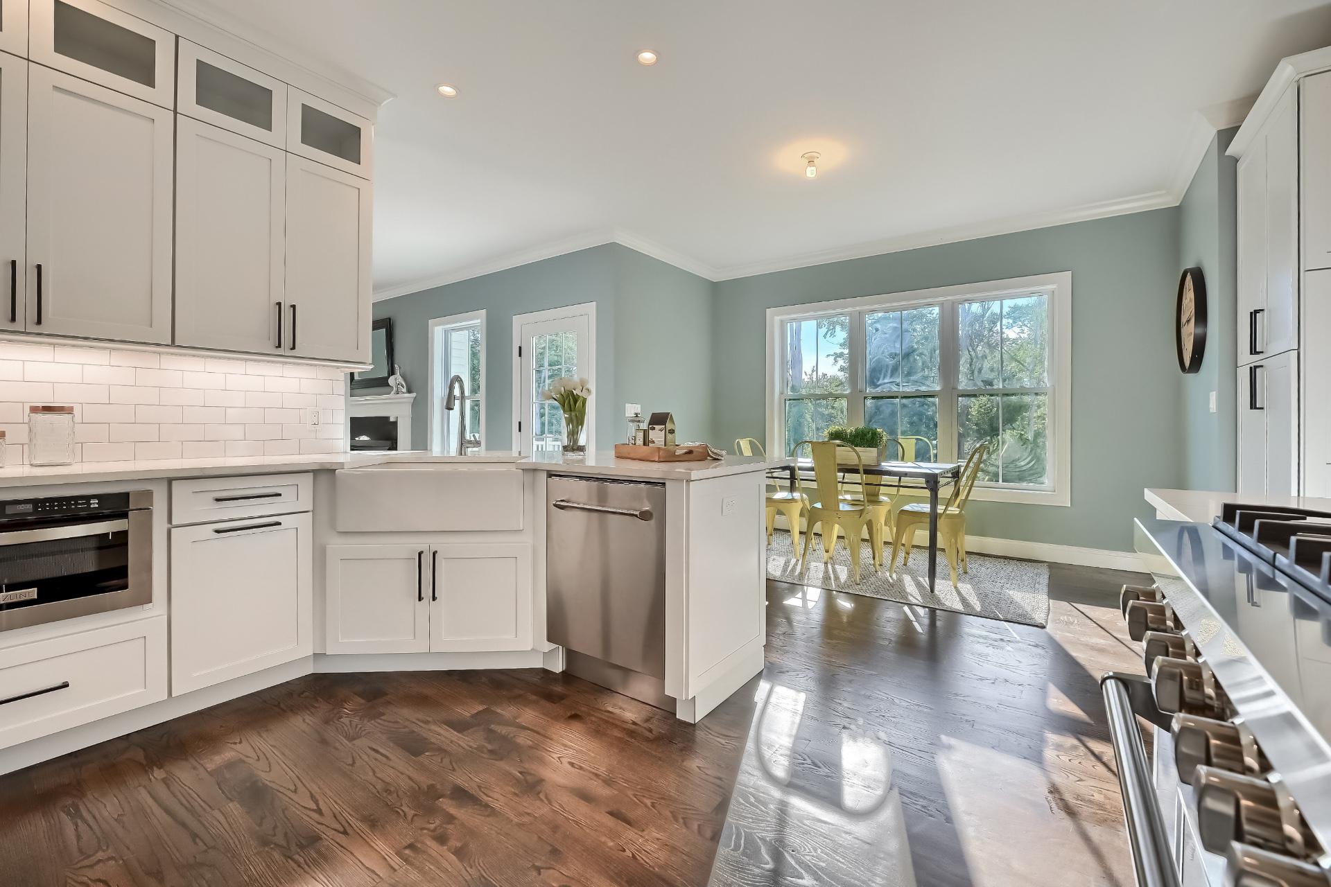 A kitchen with white cabinets and stainless steel appliances