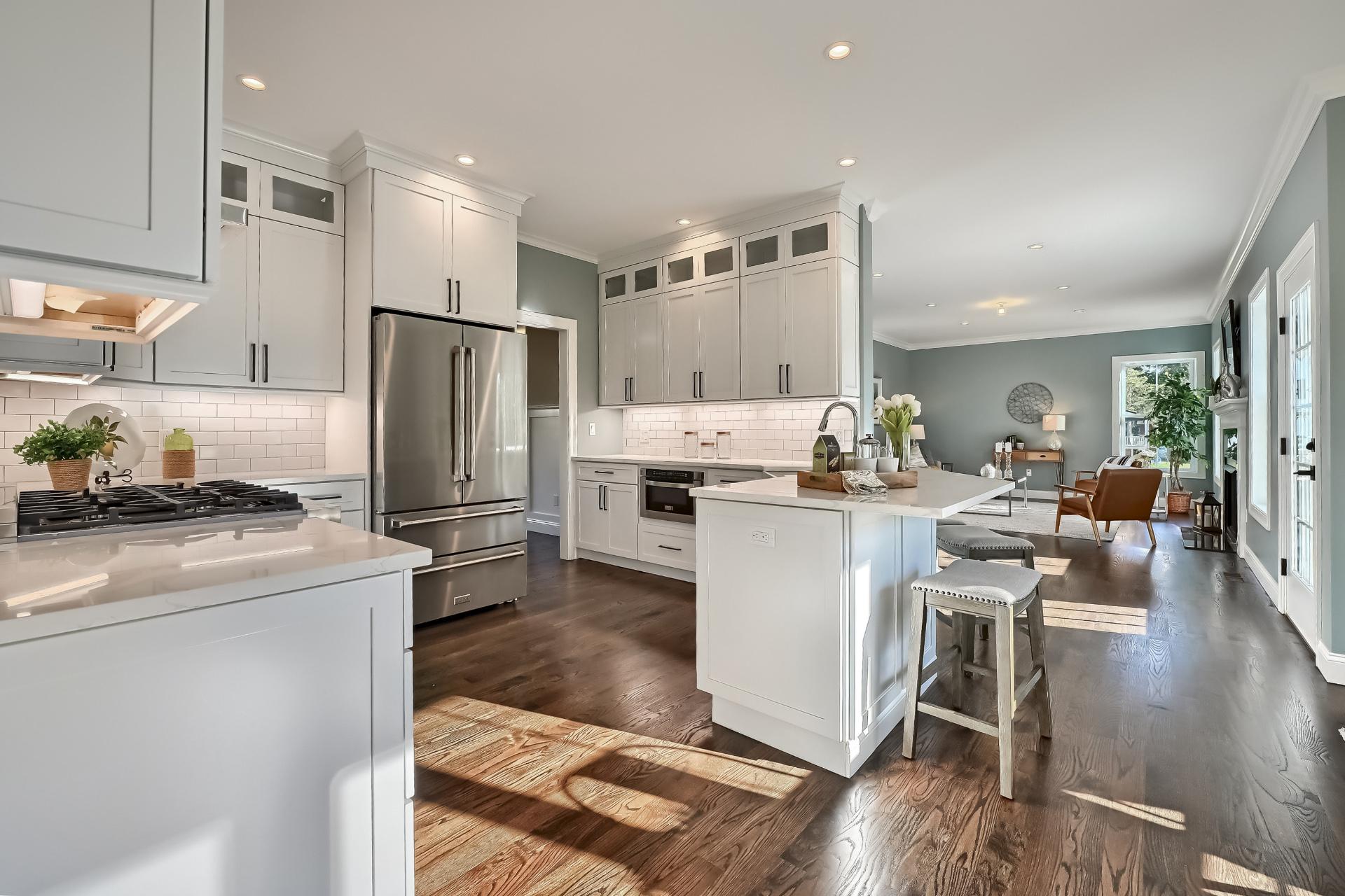 A kitchen with white cabinets and stainless steel appliances