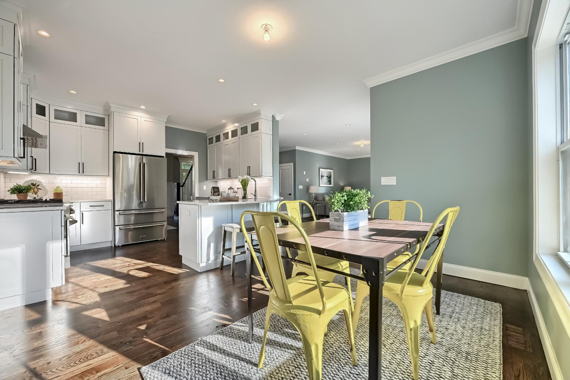 A kitchen and dining room in a house with a table and chairs.
