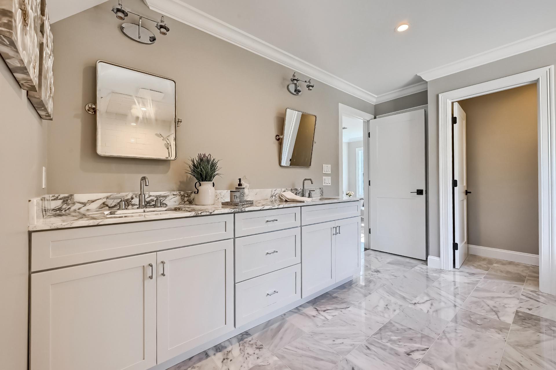 A bathroom with two sinks and a mirror on the wall.