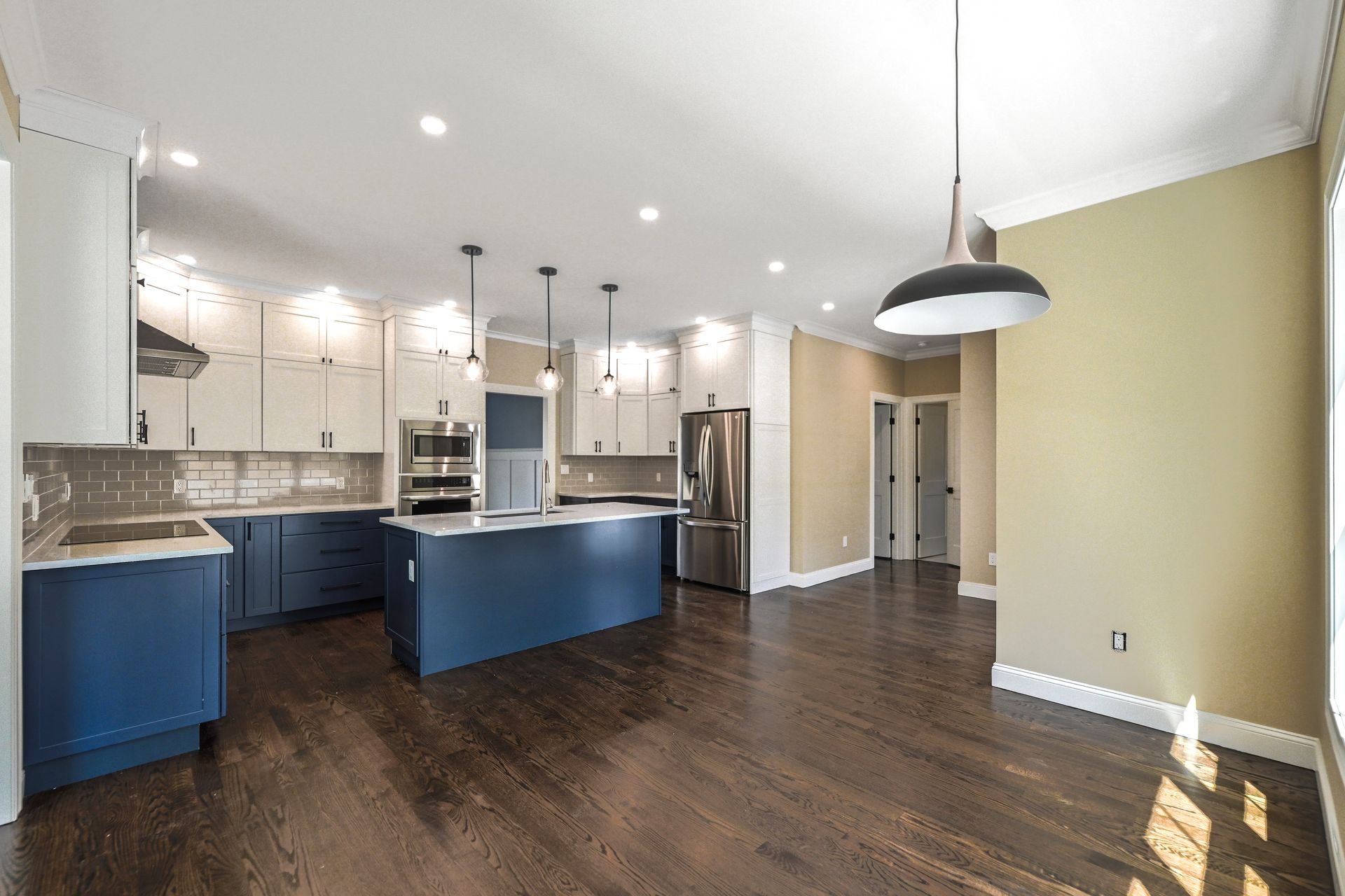 A kitchen with blue cabinets and stainless steel appliances