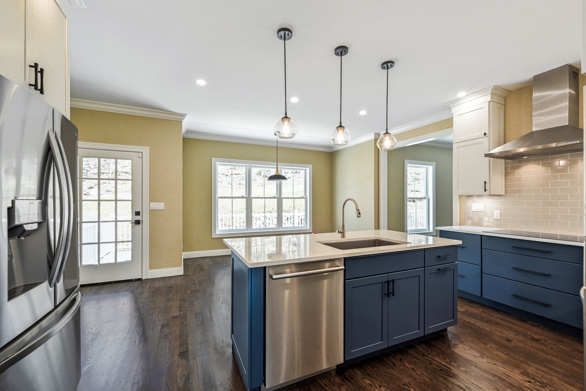 A kitchen with blue cabinets and stainless steel appliances