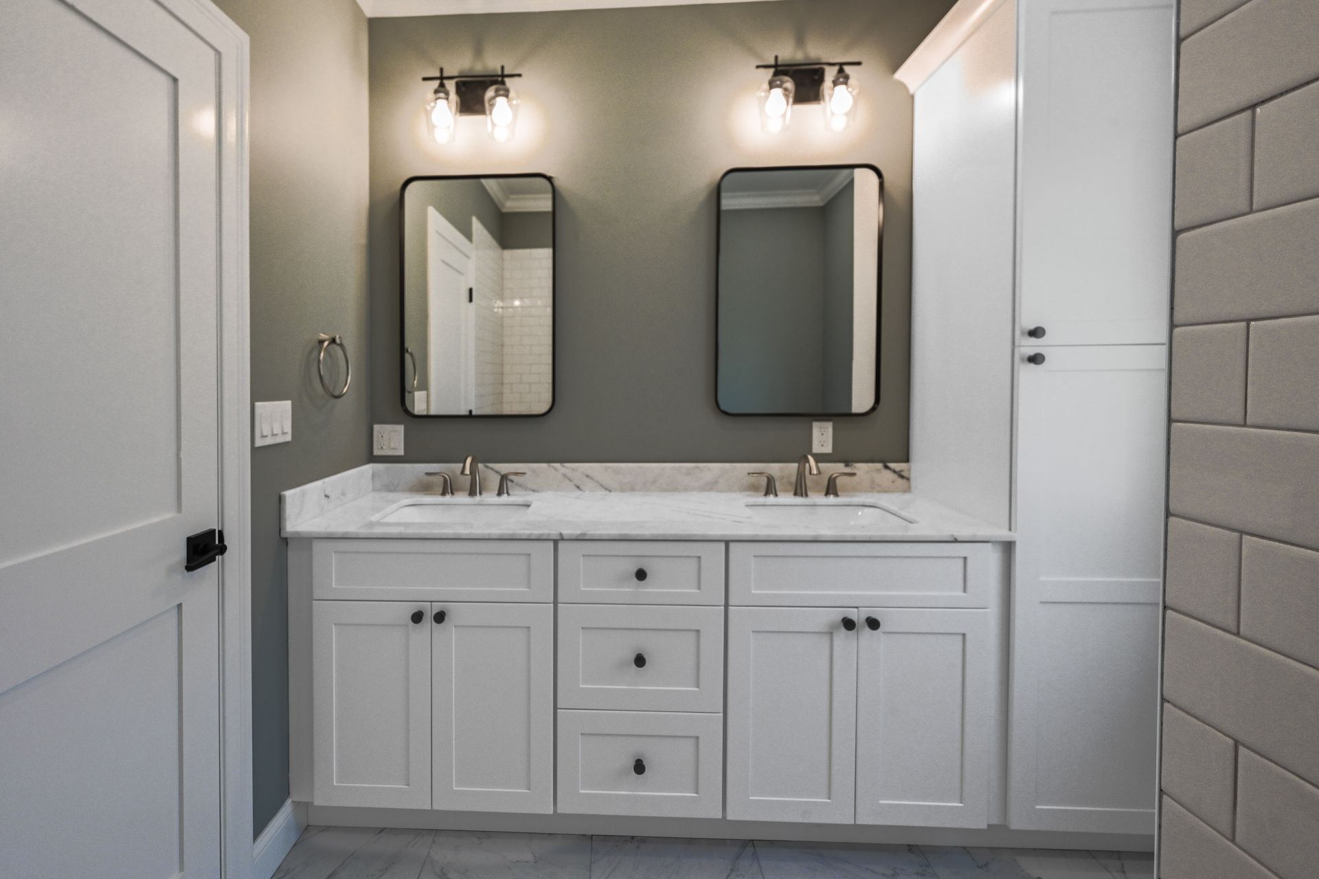 A bathroom with two sinks and two mirrors.
