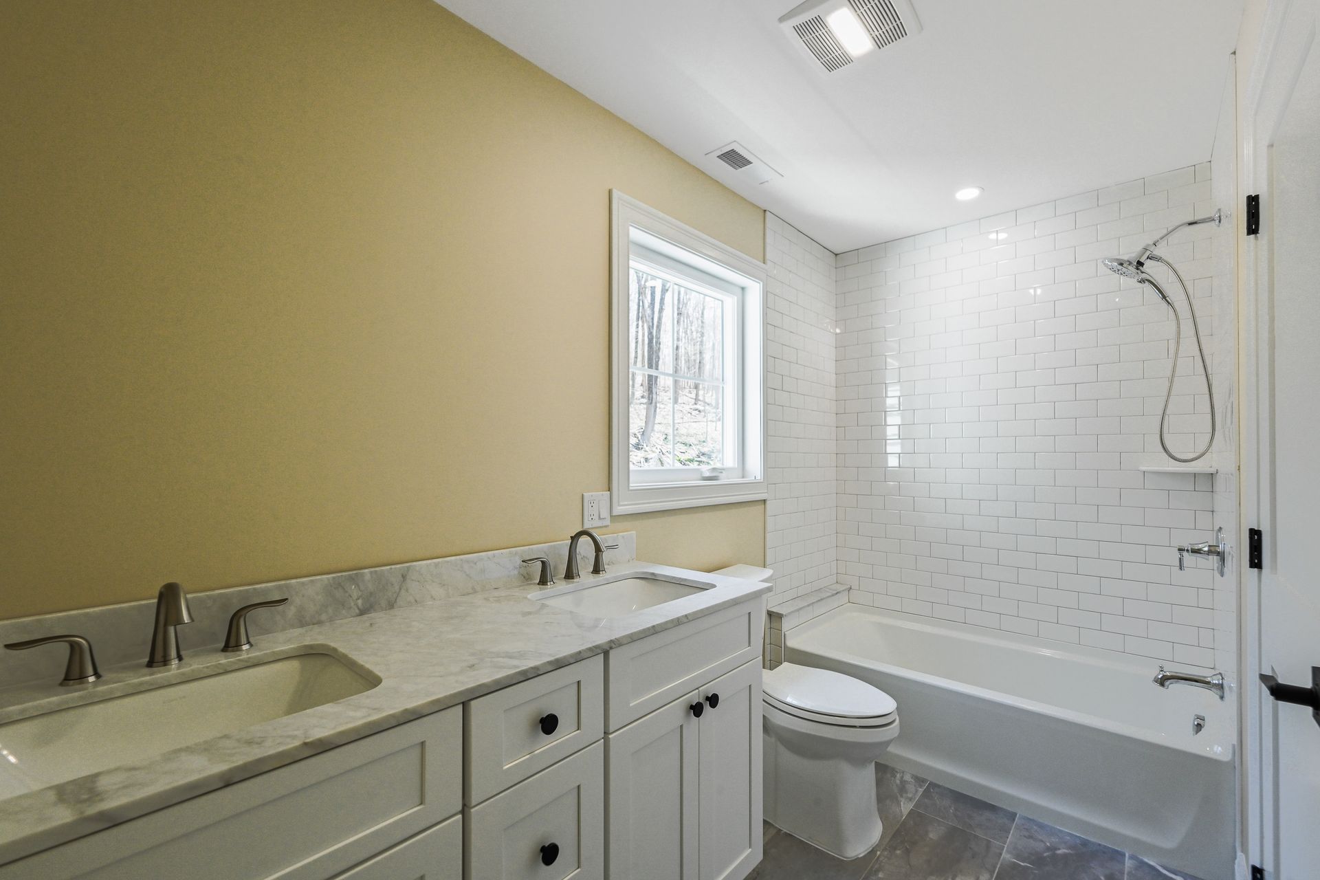A bathroom with a sink , toilet , tub and shower.