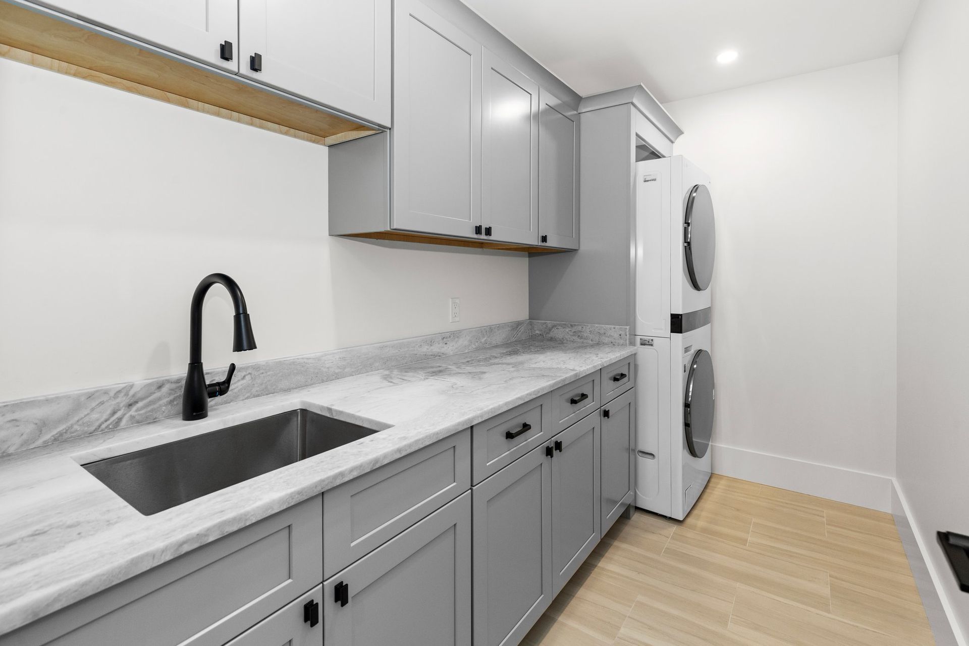 A laundry room with a sink and washer and dryer