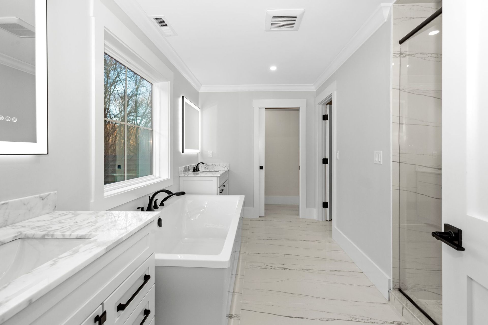 A bathroom with a tub , sink , and shower.