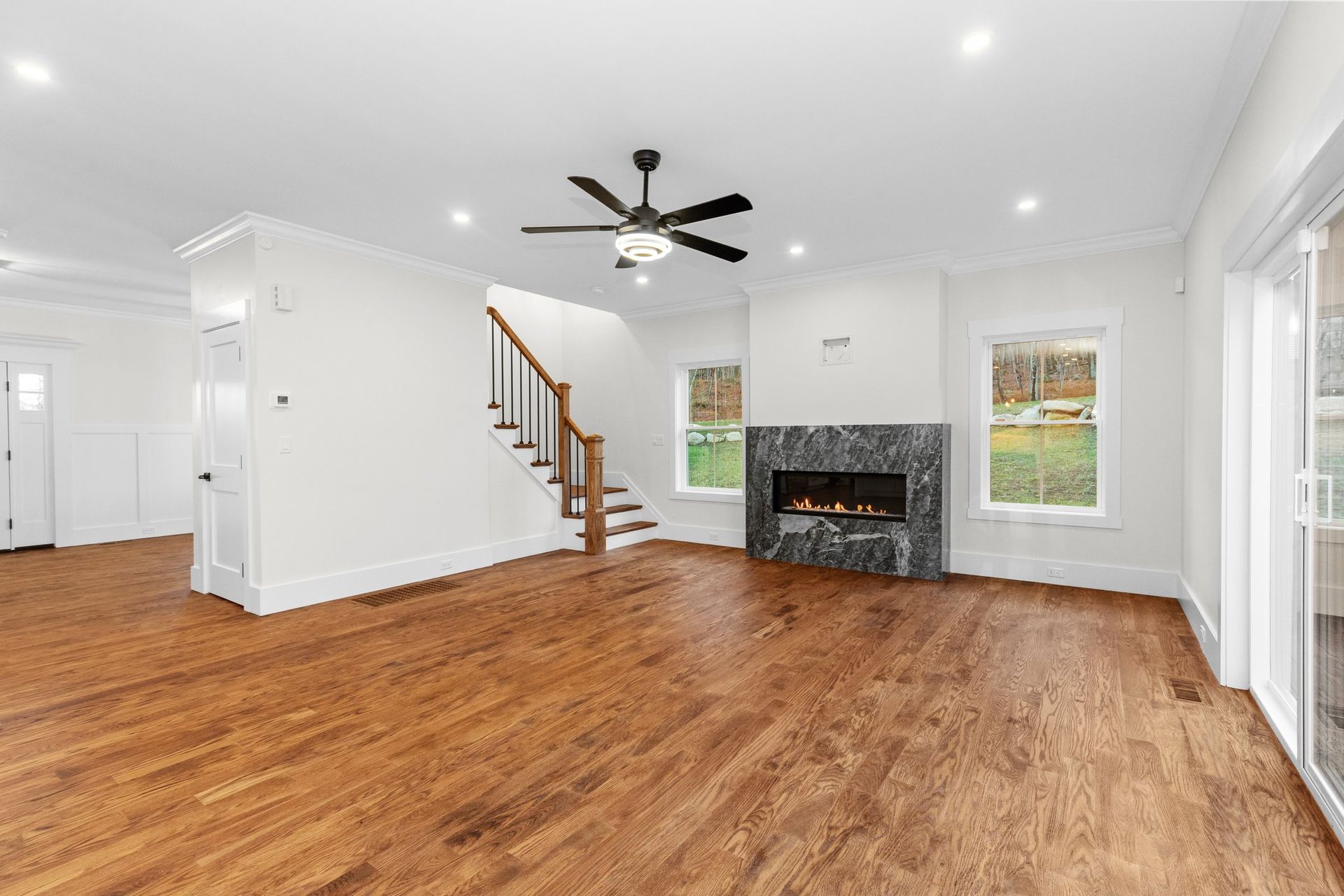 A living room with hardwood floors and a fireplace