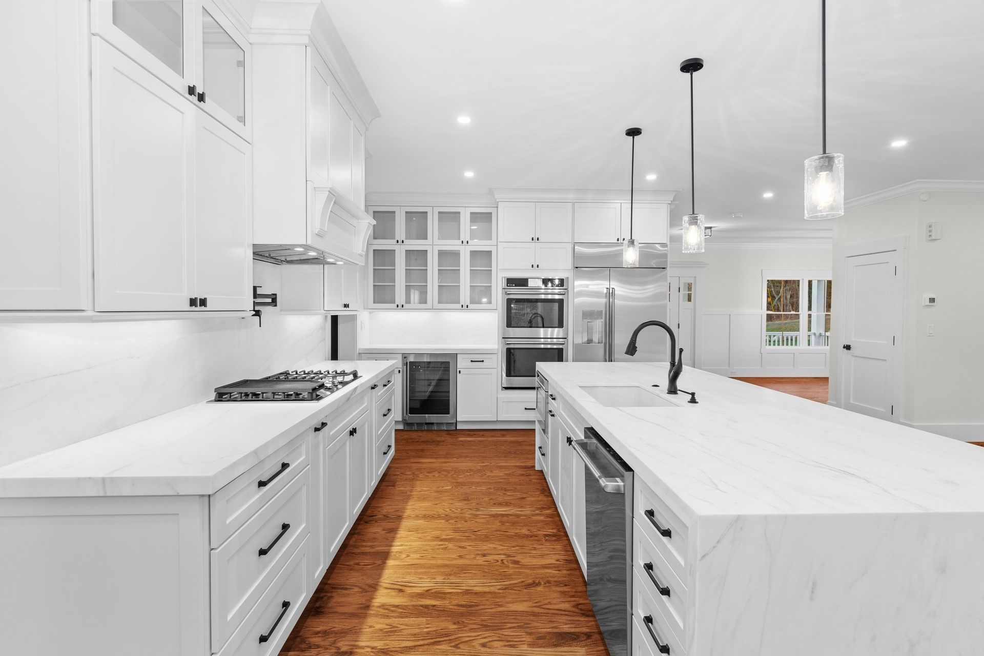 A kitchen with white cabinets and stainless steel appliances