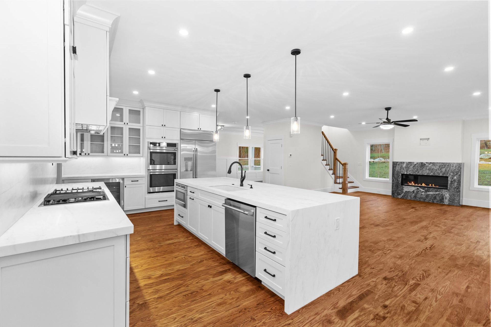 A kitchen with white cabinets and stainless steel appliances
