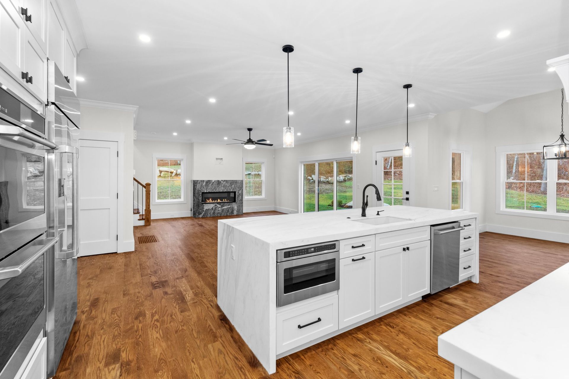 A kitchen with white cabinets and stainless steel appliances