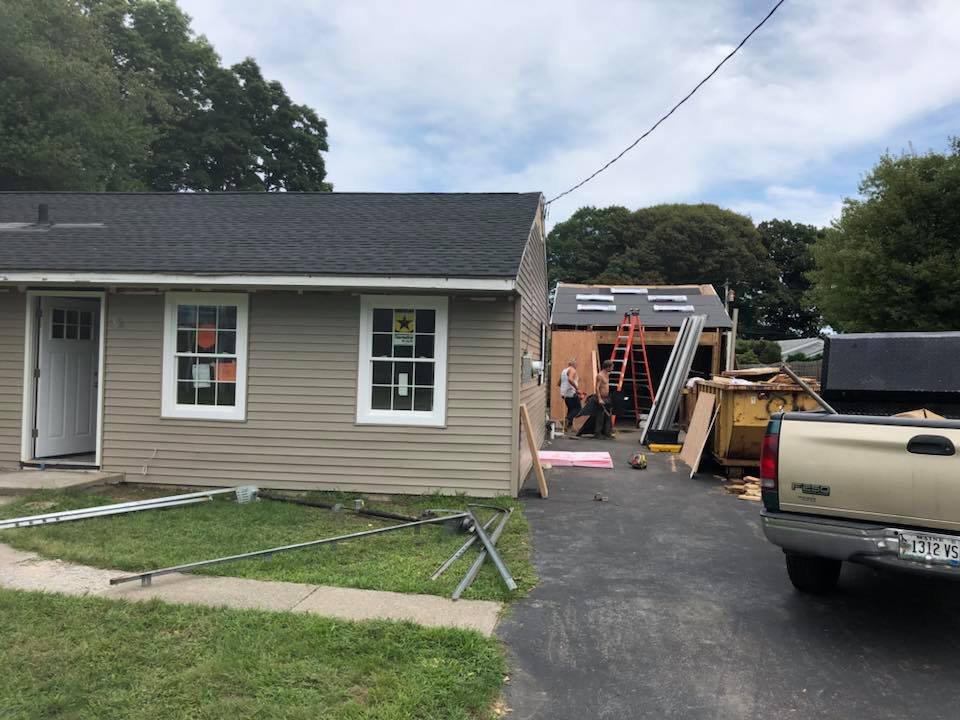 A truck is parked in front of a house under construction.