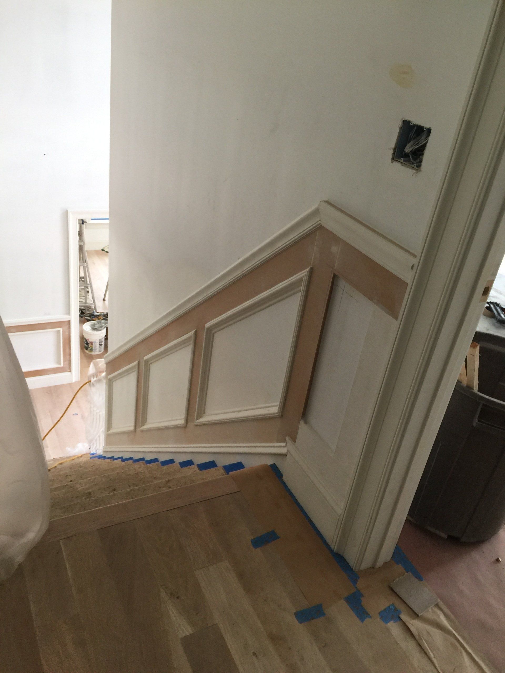 A staircase is being painted in a house