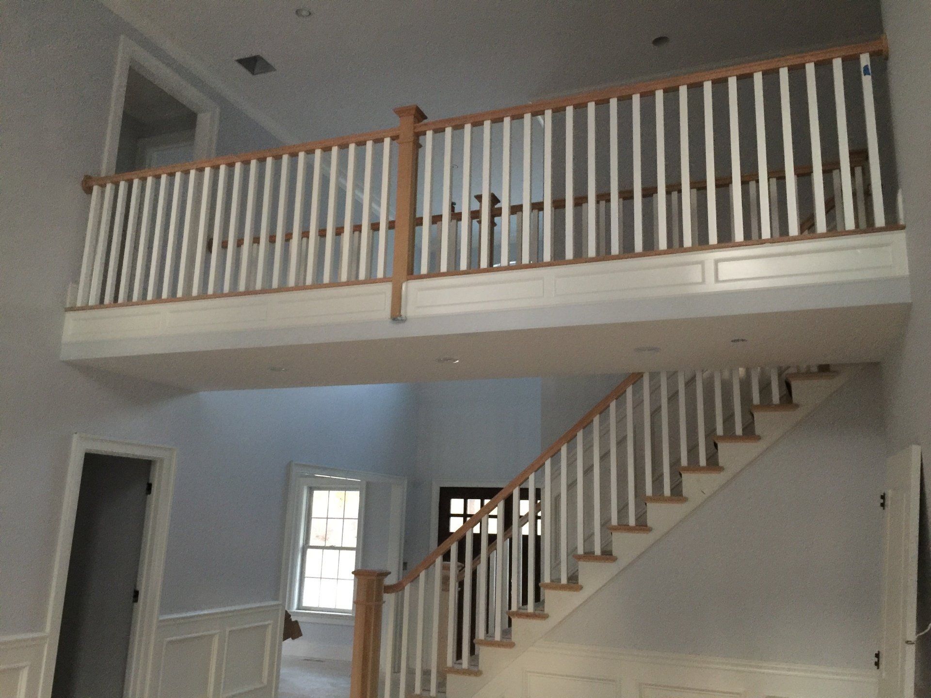 A staircase with a wooden railing leading up to the second floor
