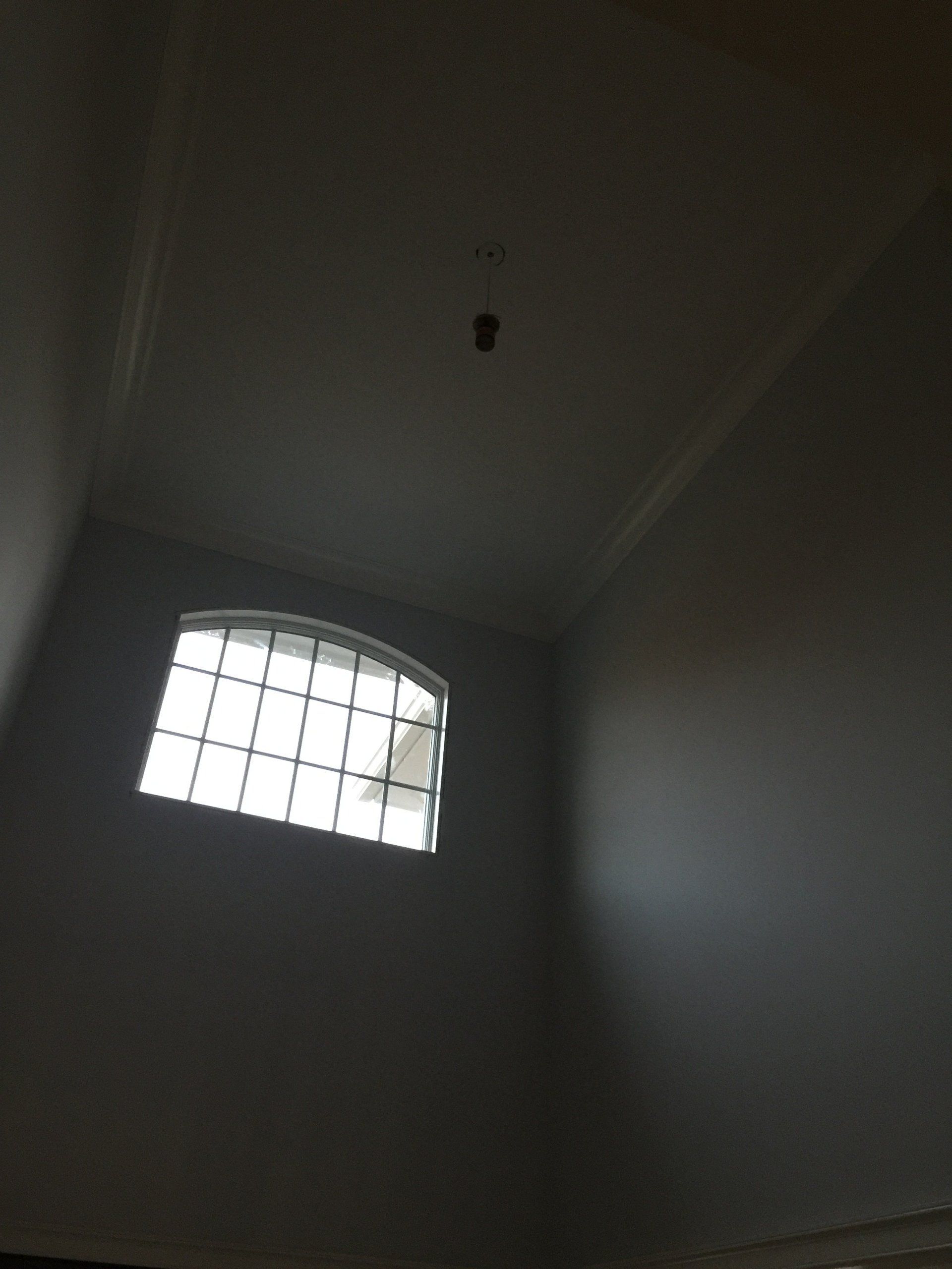 Looking up at a window in a dark room