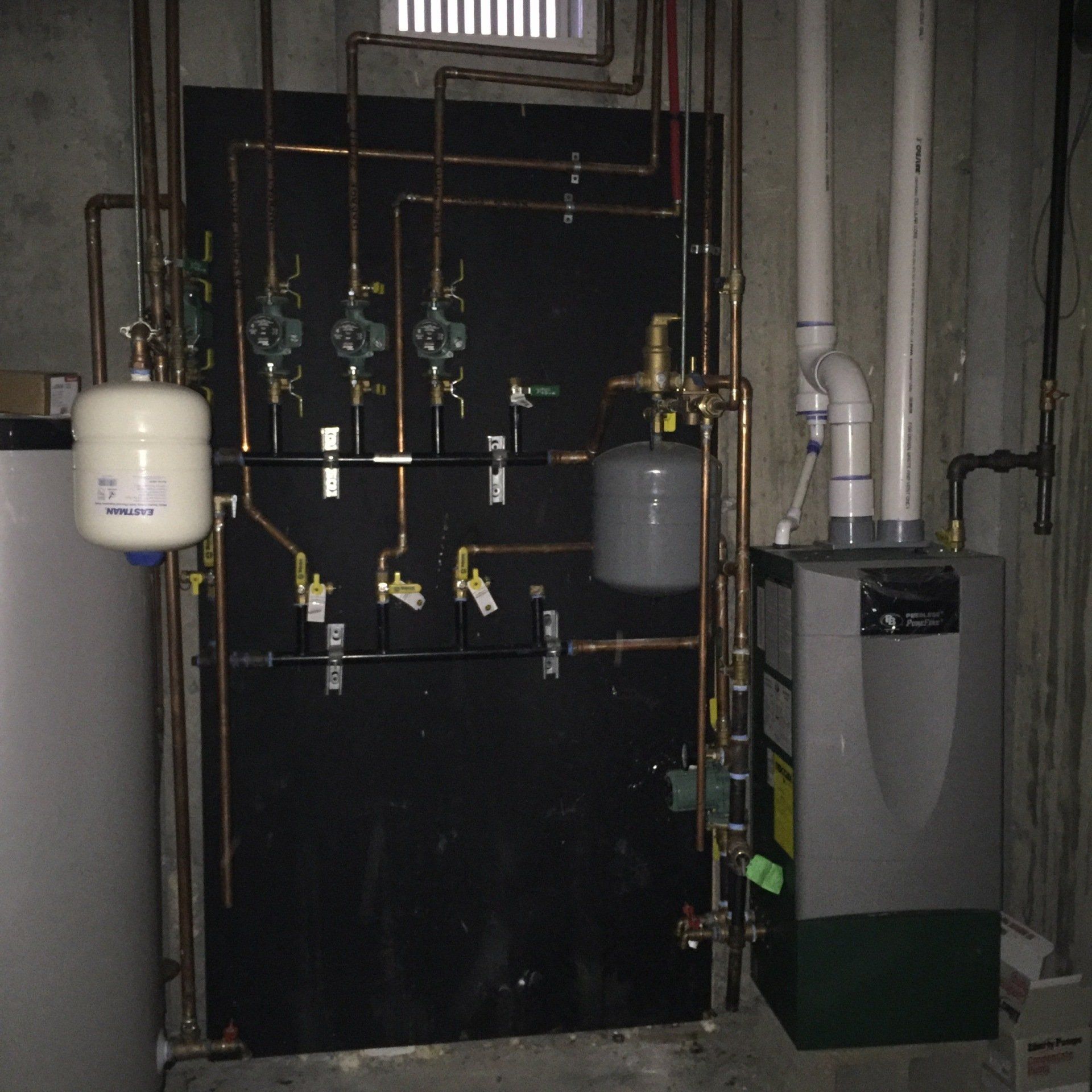 A room with a boiler and a water tank