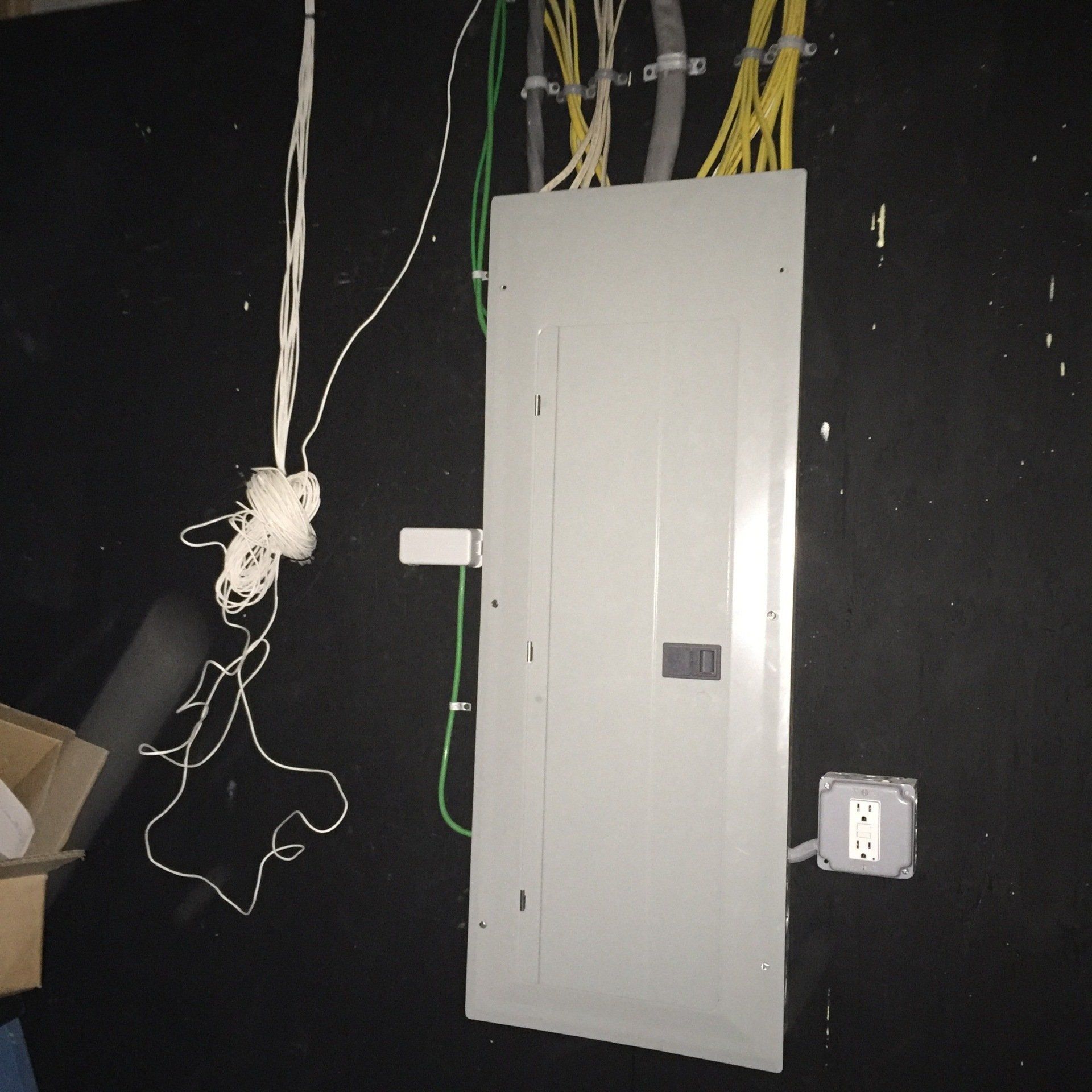 An electrical box with wires hanging off of it