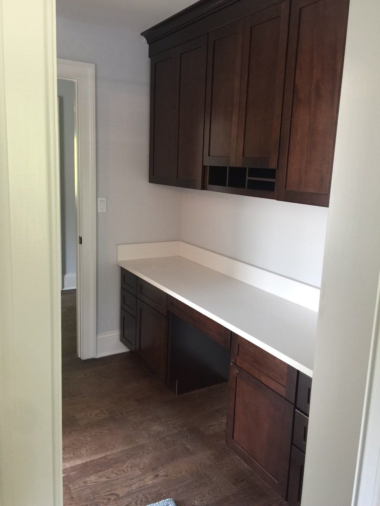 A room with a desk and cabinets in it.