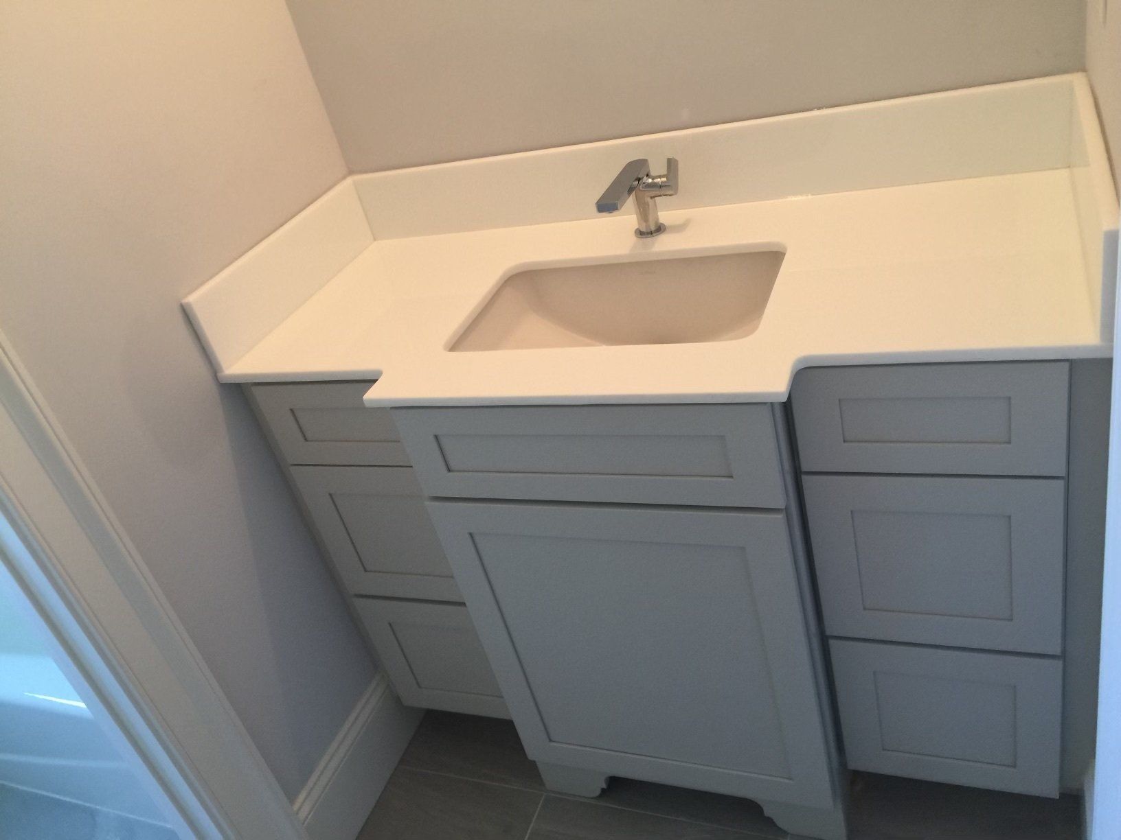 A bathroom vanity with a sink and a faucet