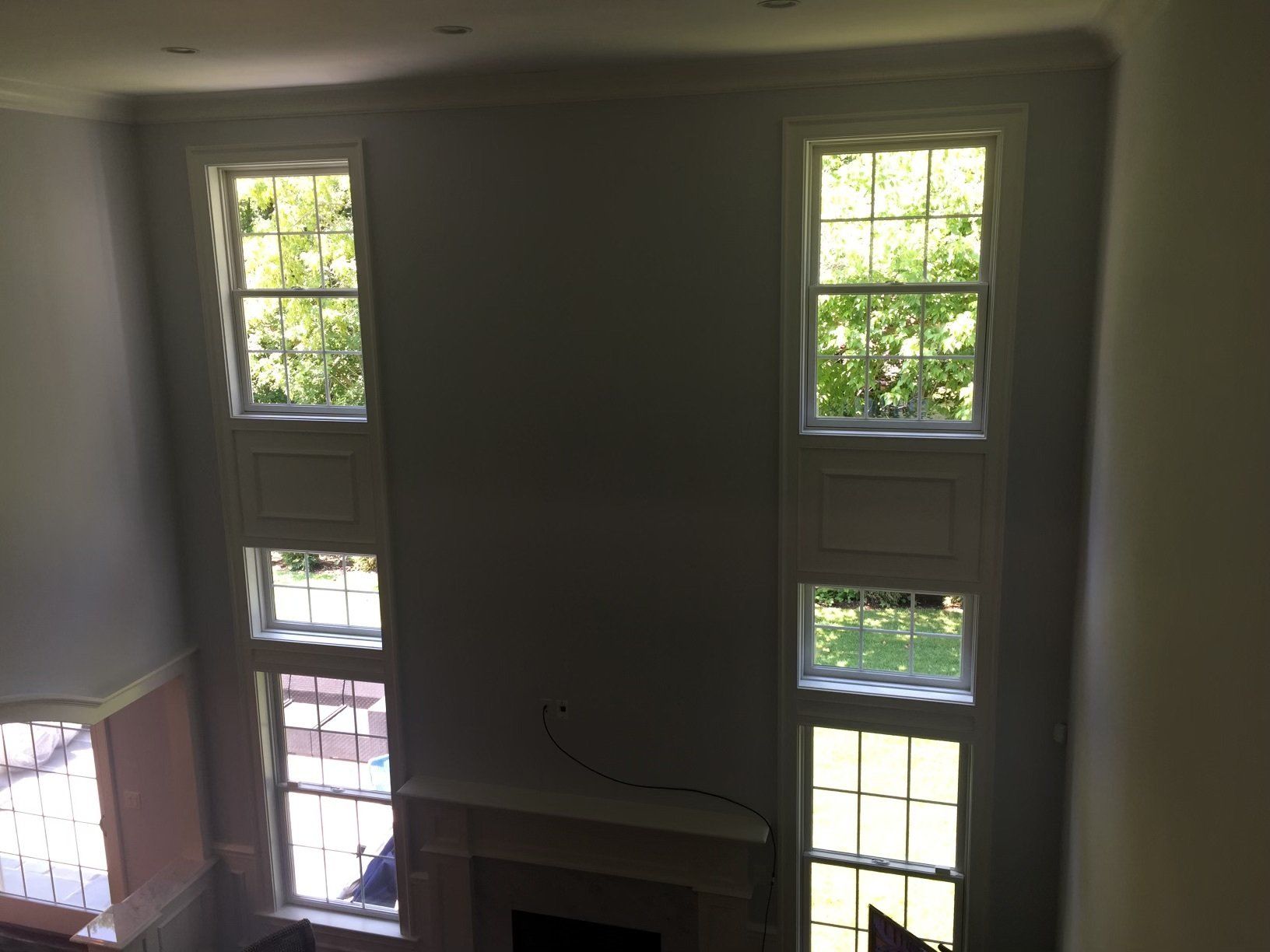 A living room with a fireplace and lots of windows