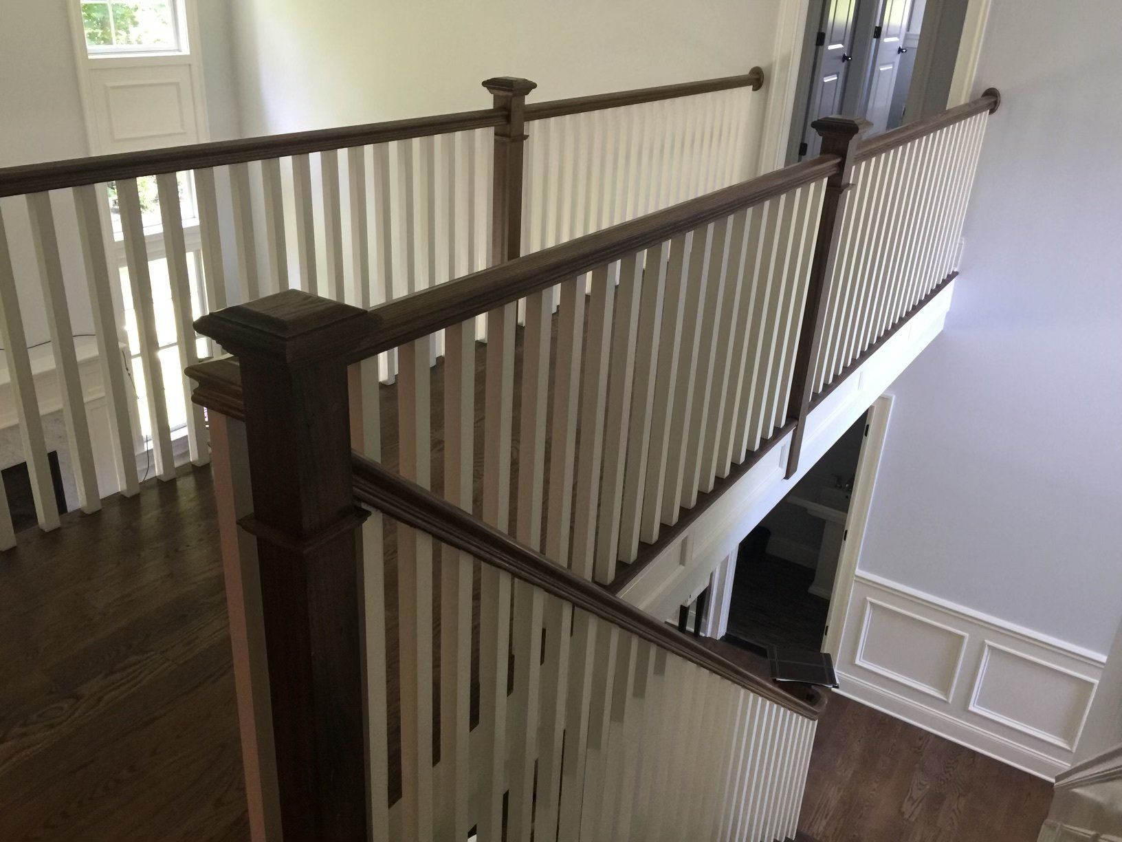 A view of a staircase from the second floor of a house.