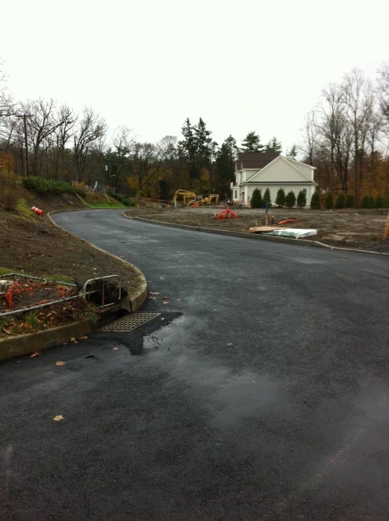 A house is being built on the side of a road