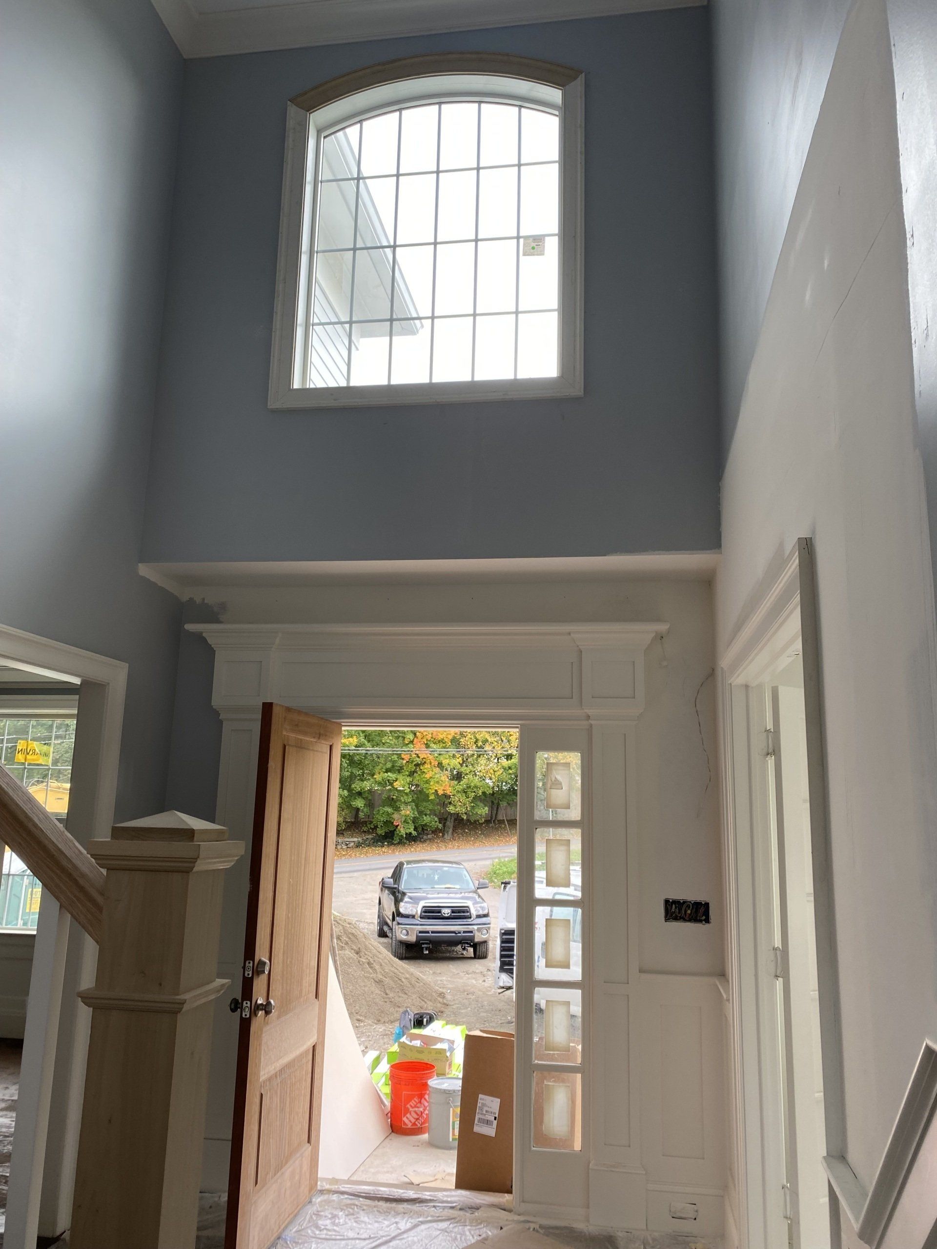 The door is open and there is a large window in the hallway.