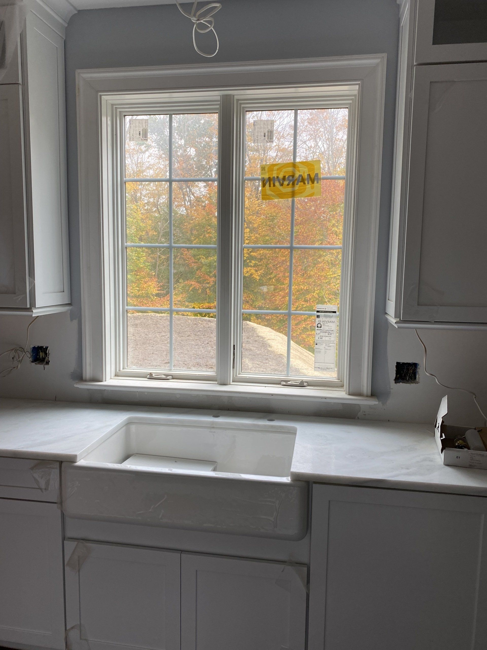 A kitchen with a sink and a large window
