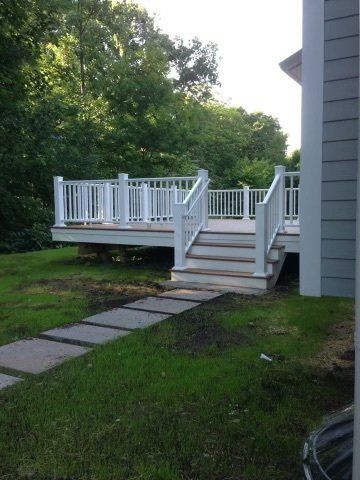 A white deck with stairs leading up to it
