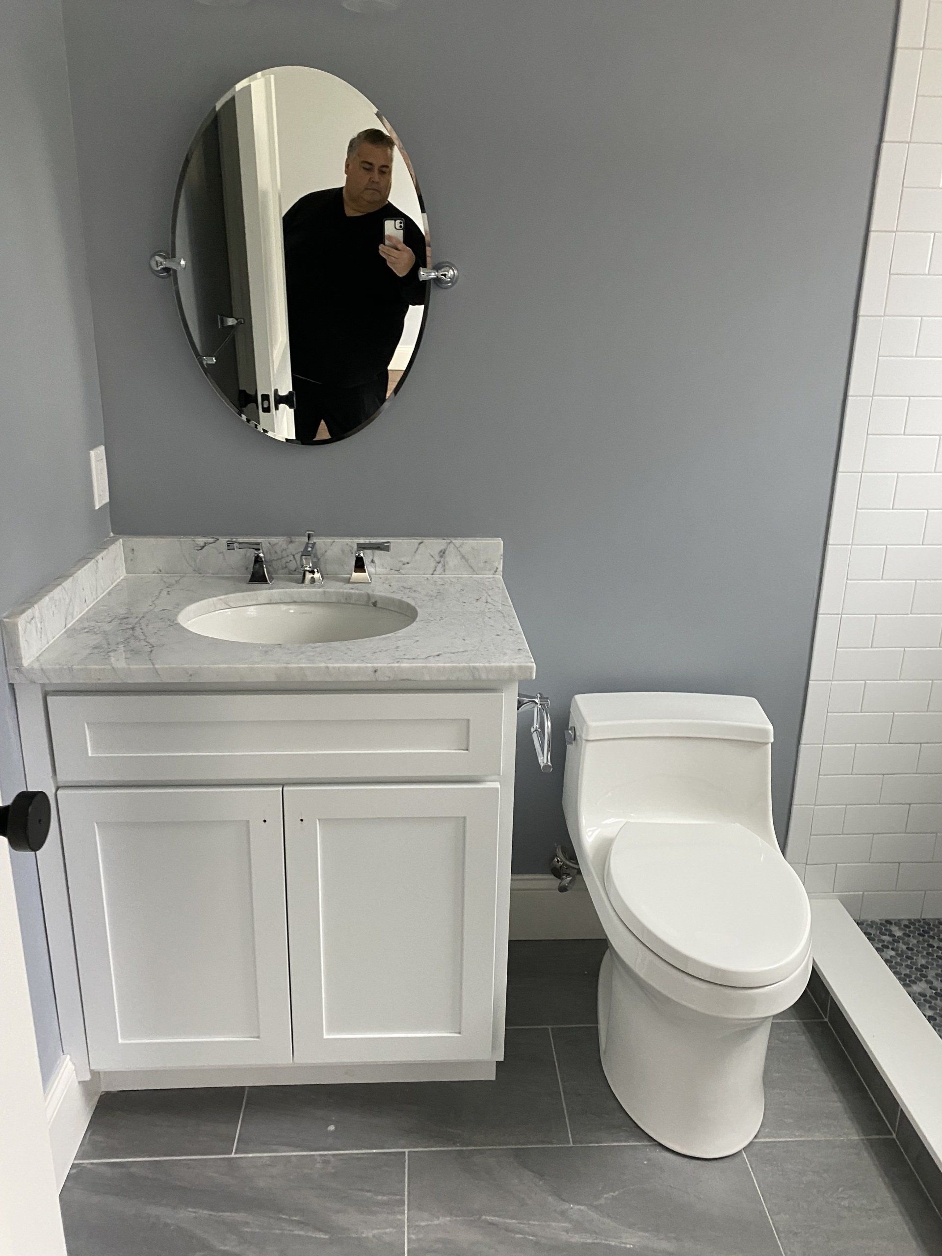 A bathroom with a sink , toilet , and mirror.