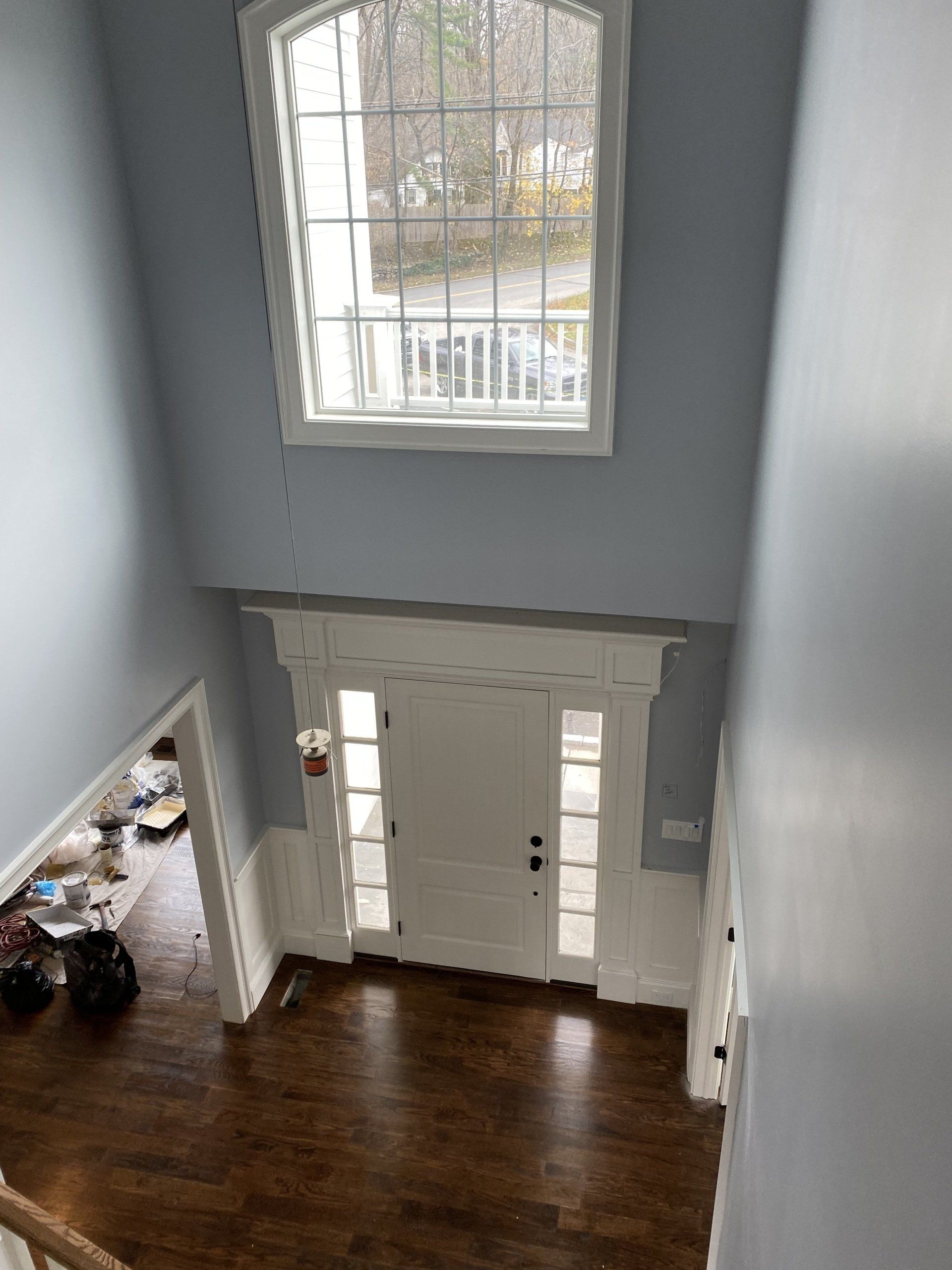 An aerial view of a living room with hardwood floors and a large window.