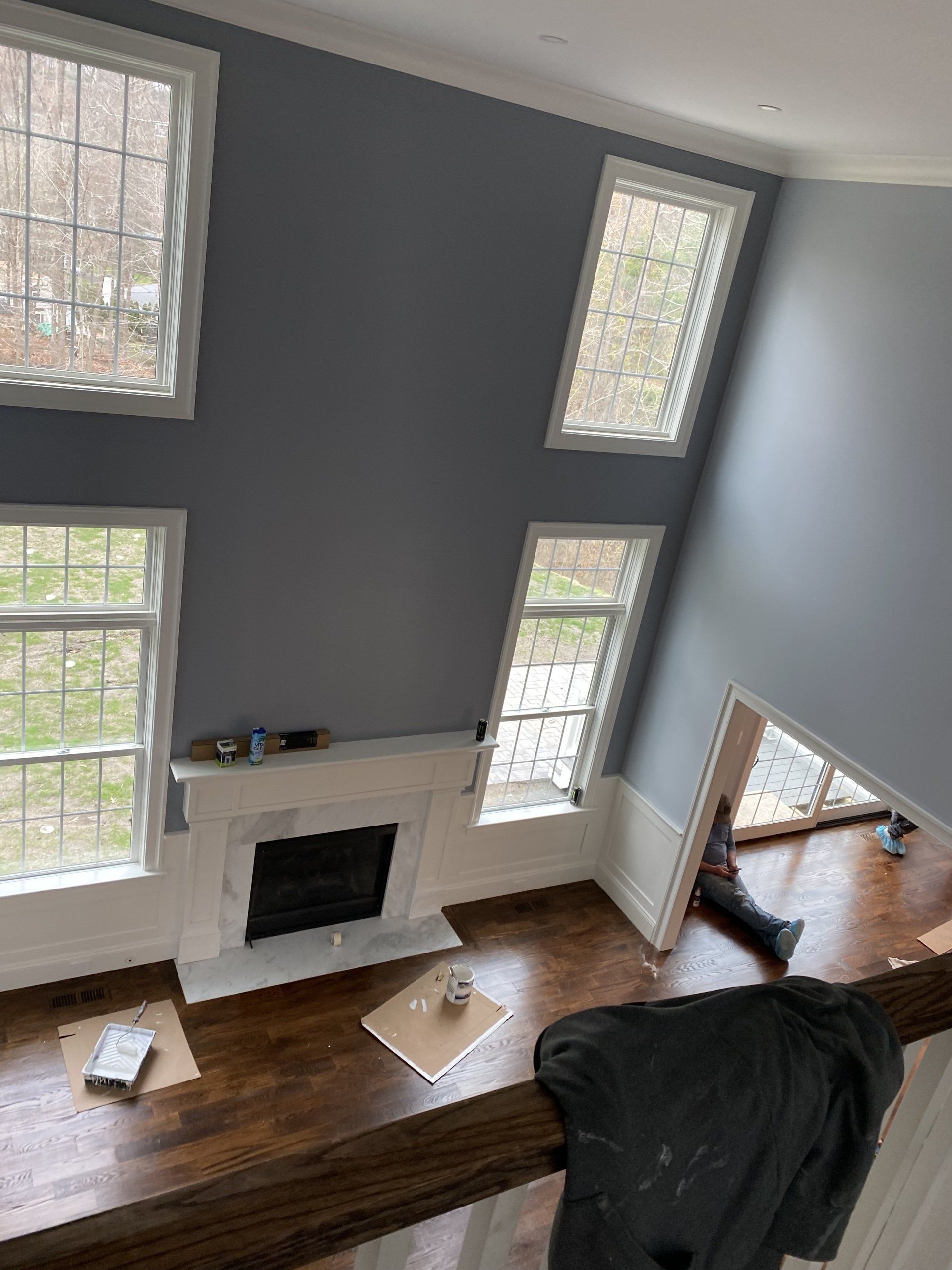 An aerial view of a living room with a fireplace and lots of windows.