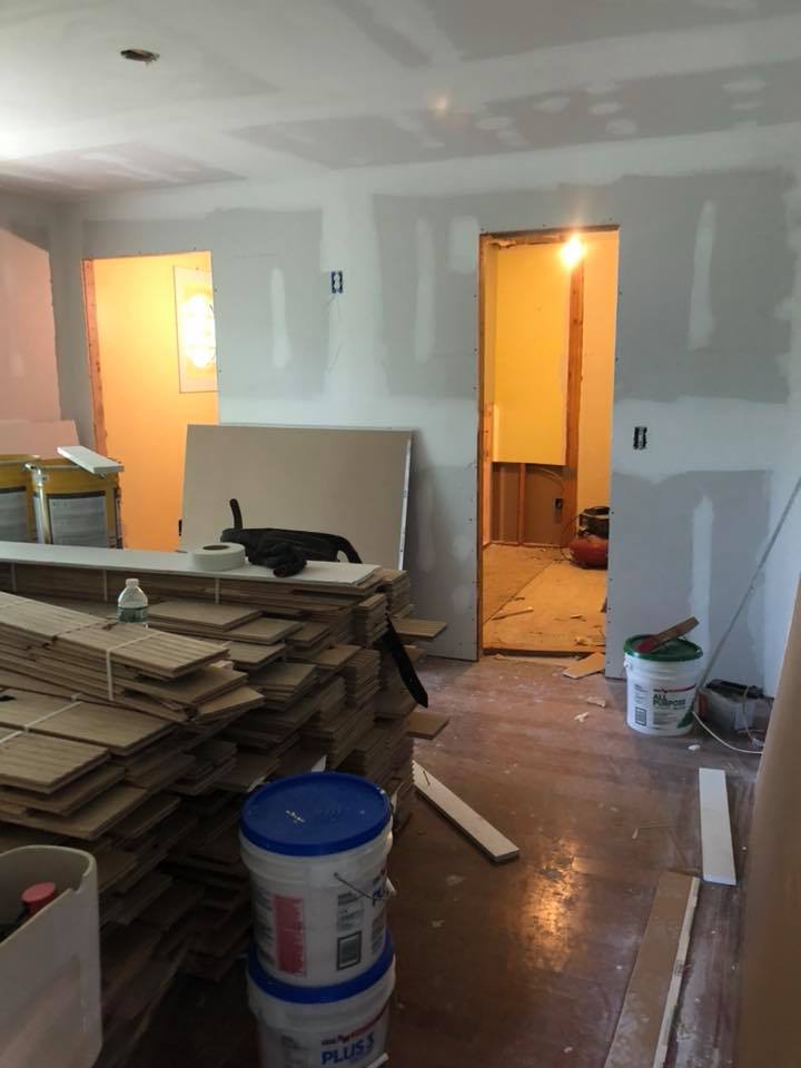 A room with a stack of wood and buckets of paint