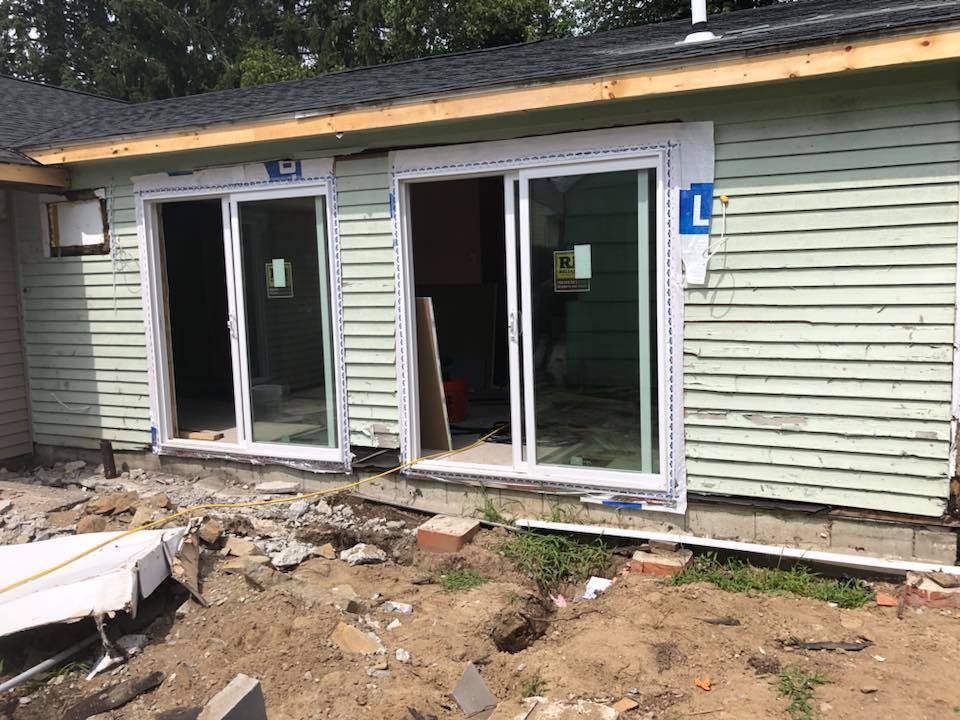A house with sliding glass doors is being remodeled.