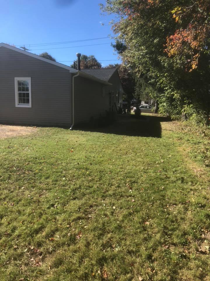 A house with a lot of grass in front of it.
